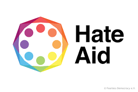 Hate Aid Logo: Outline of hexagon rainbow with dots inside.